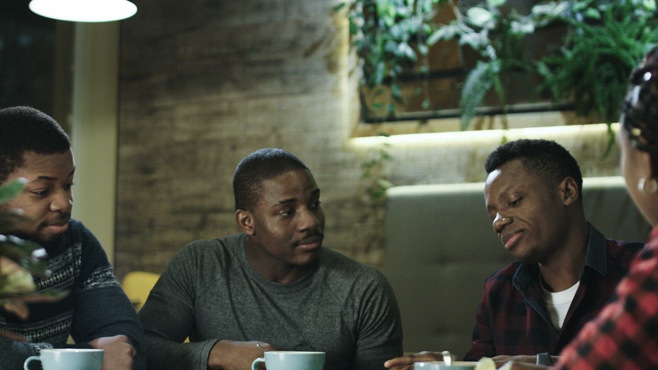 mixkit-group-of-friends-having-a-discussion-in-the-table-23381-0.jpg