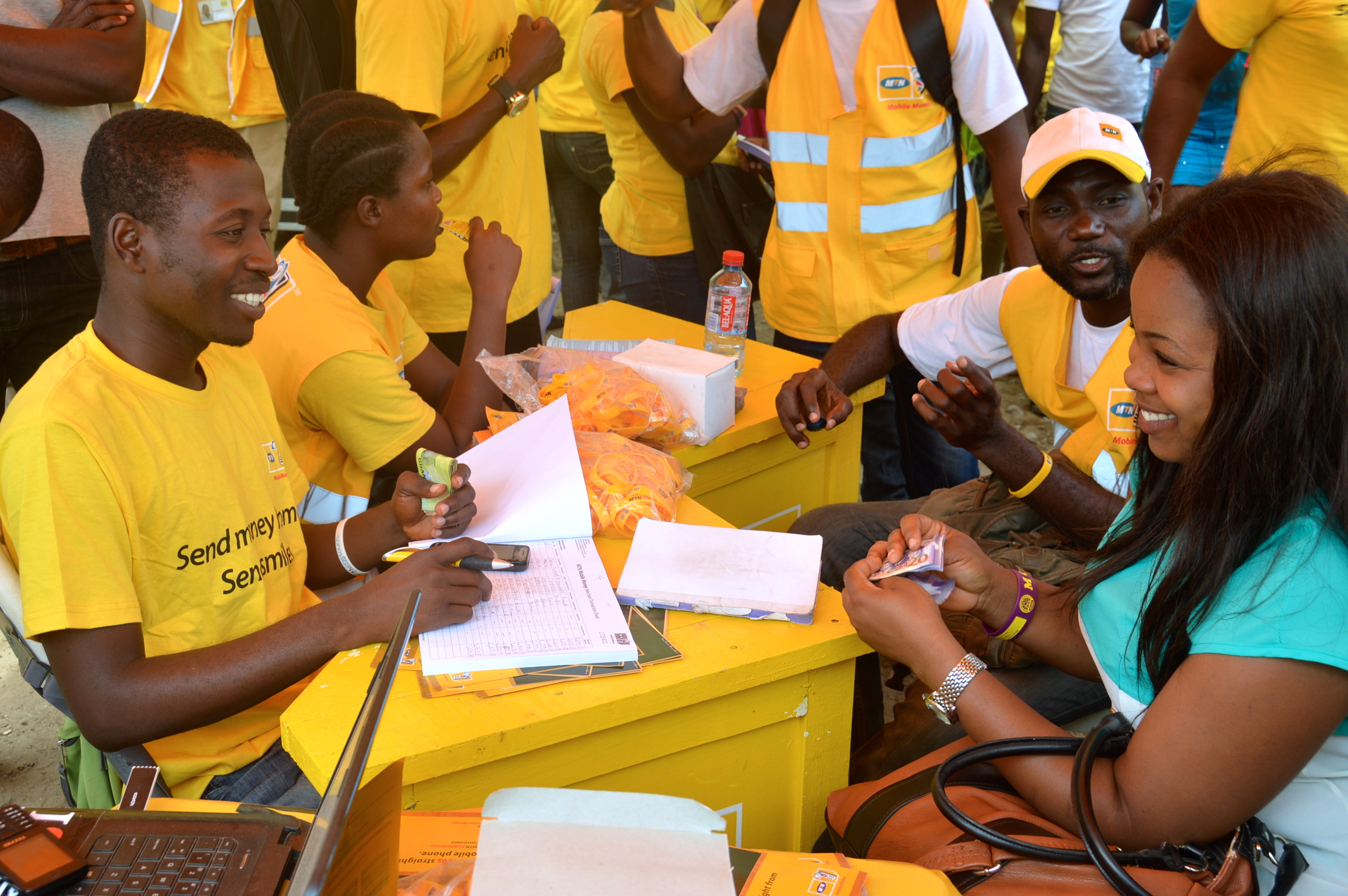 MTN-Mobile-Money-Official-attending-to-a-customer.jpg