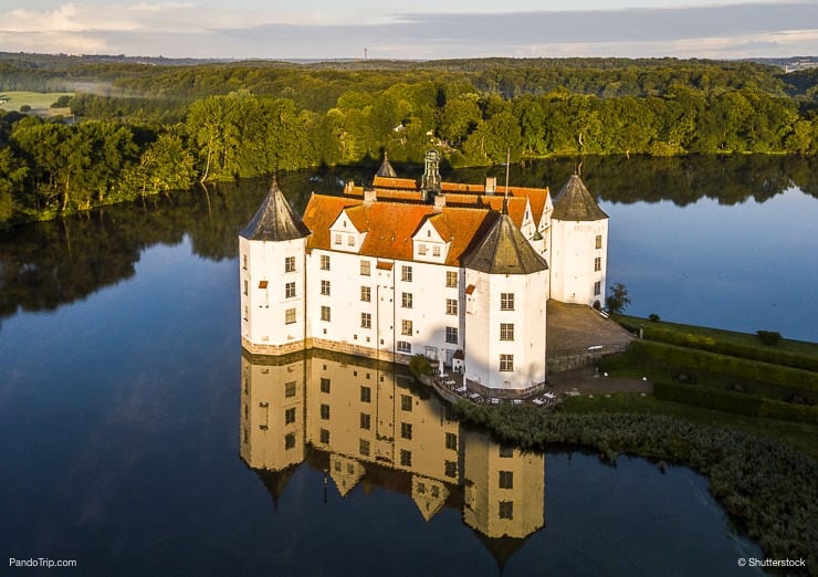 Aerial-Drone-View-of-Glucksburg-water-castle-at-dawn-Germany.jpg