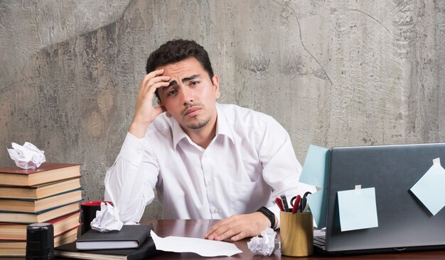 young-businessman-looking-tired-office-desk_114579-28426.jpg