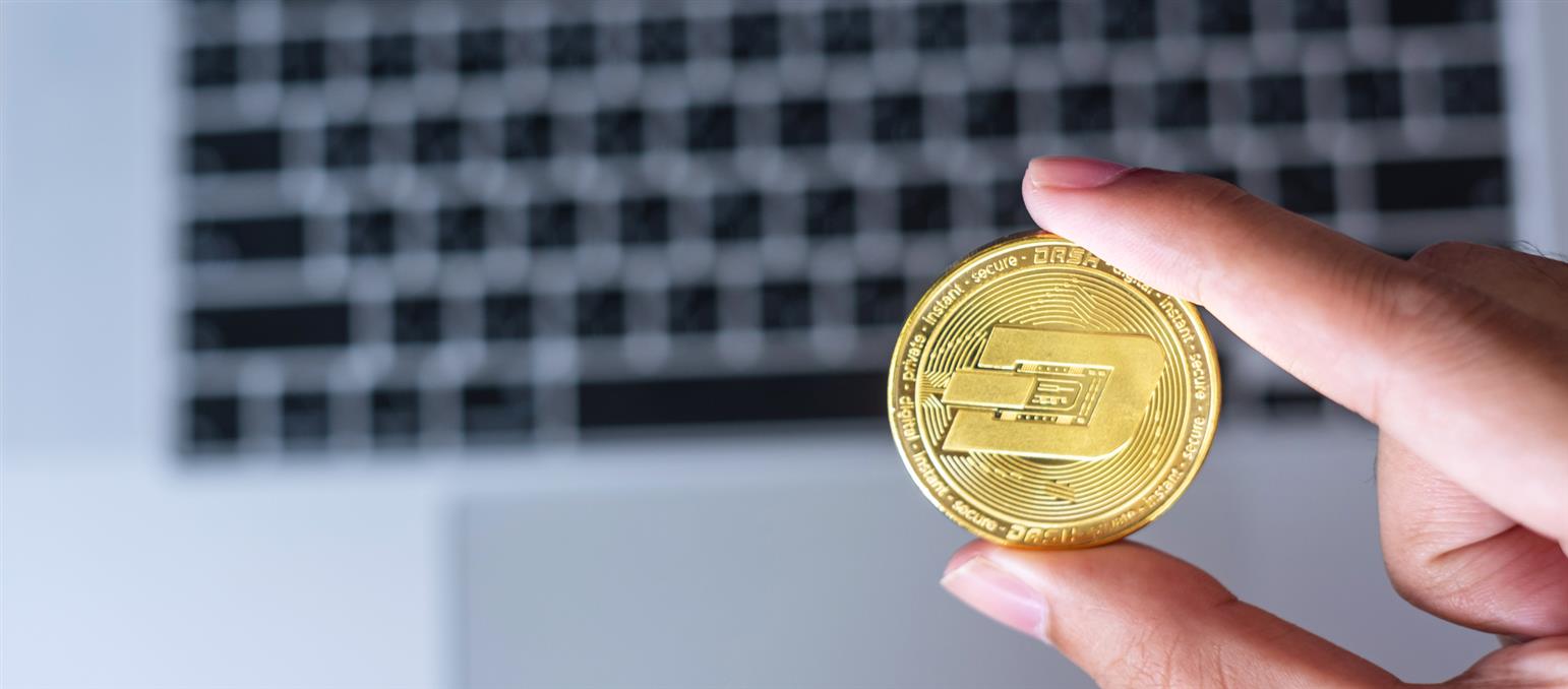 1920-businessman-hand-holding-golden-dash-cryptocurrency-coin-over-keyboard-laptop-crypto-is-digital-money-within-the-blockchain-network.jpg