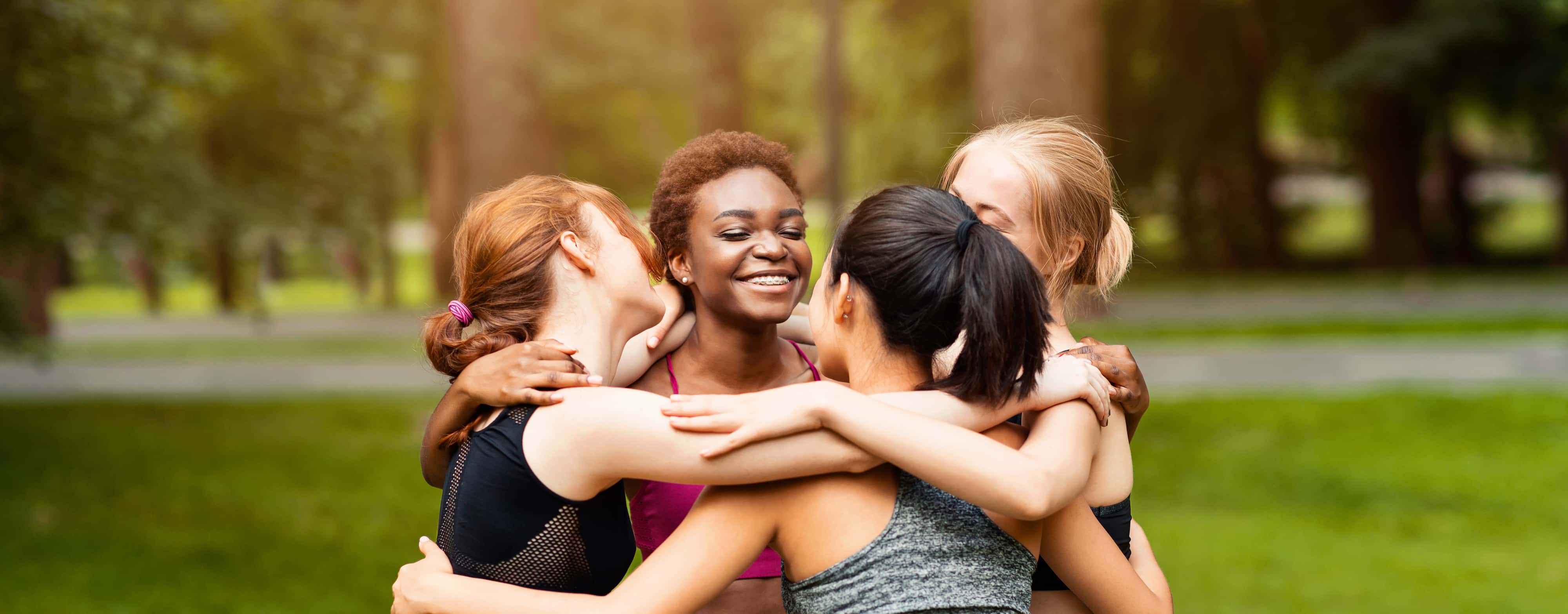 diverse-young-girls-in-sportswear-hugging-after-ou.jpg