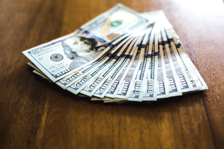 fanned-hundred-dollar-bills.webp