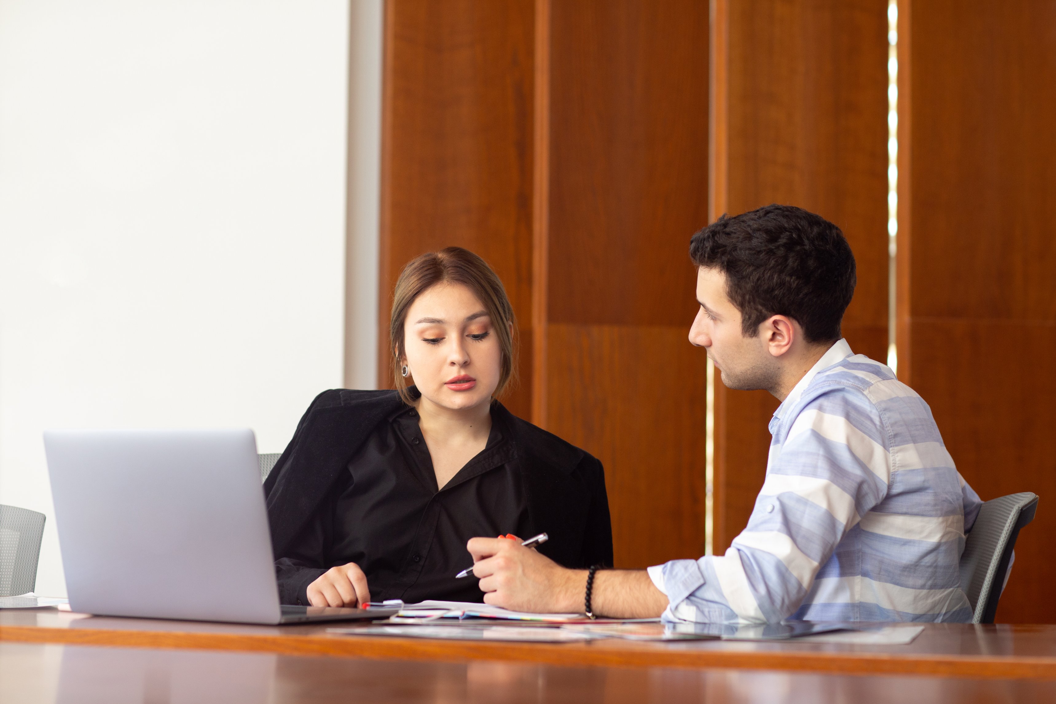 compressed_front-view-young-attractive-businesswoman-black-shirt-black-jacket-along-with-young-man-discussing-work-issues-inside-her-office-work-job-building.jpg