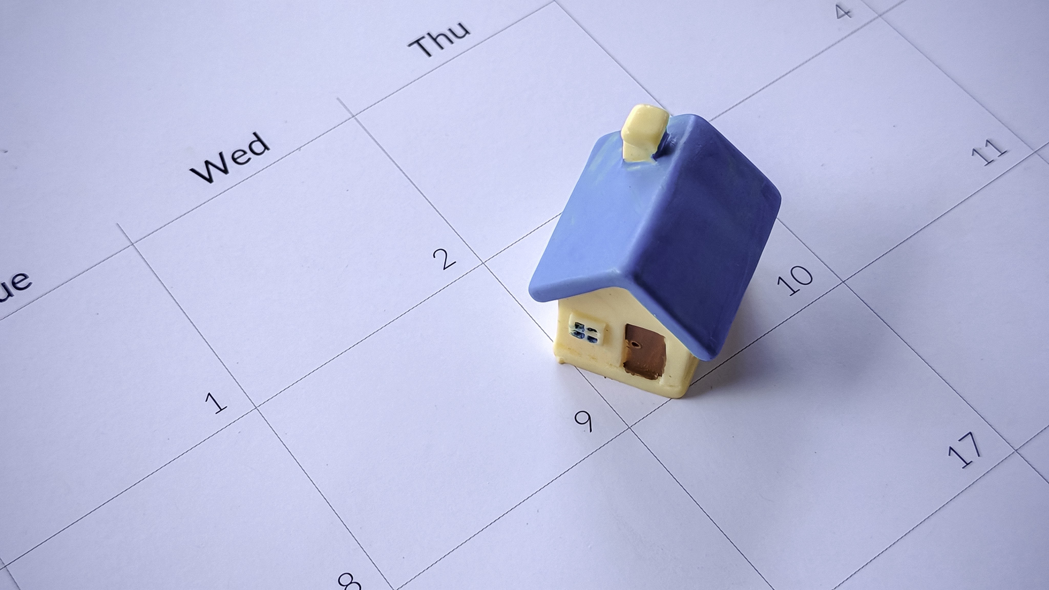 blue-toy-house-on-a-white-calendar-2026-03-25-05-05-07-utc.jpg
