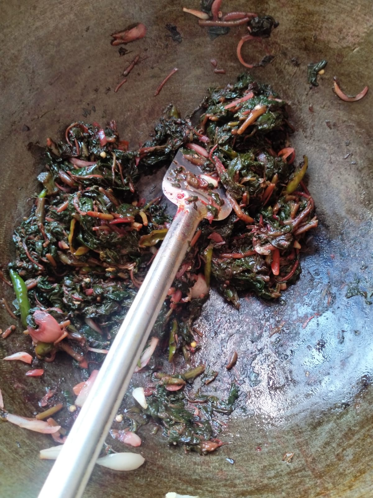 cooking lal shak.jpeg