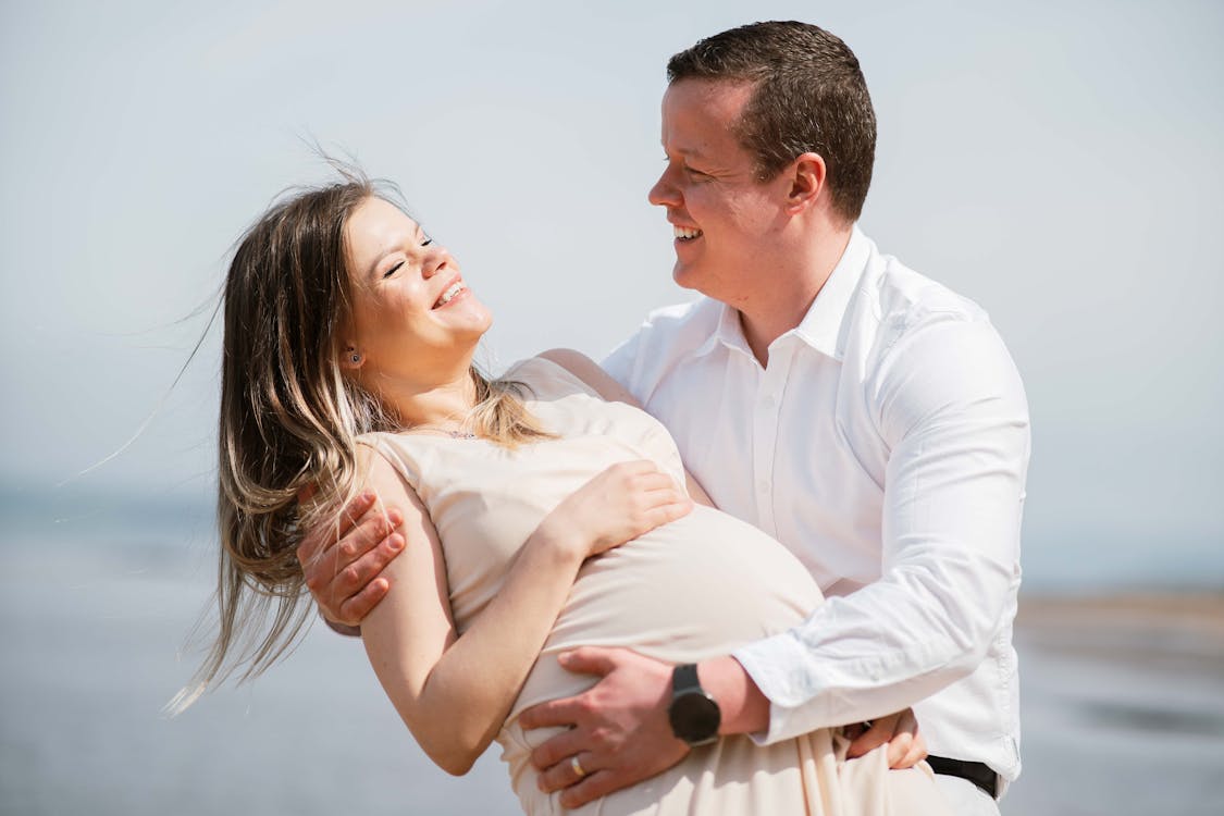 free-photo-of-happy-man-holding-his-pregnant-wife.jpeg