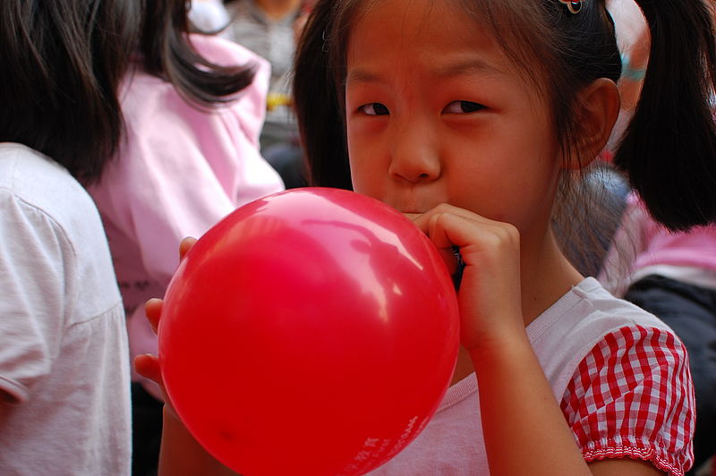 800px-Girl_inflating_a_red_balloon.jpg