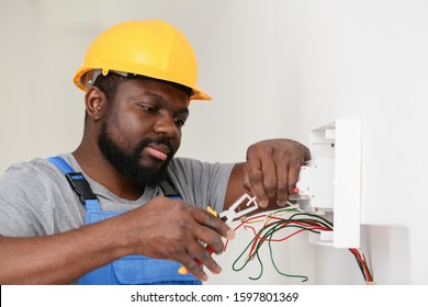 africanamerican-electrician-performing-wiring-room-260nw-1597801369.jpg