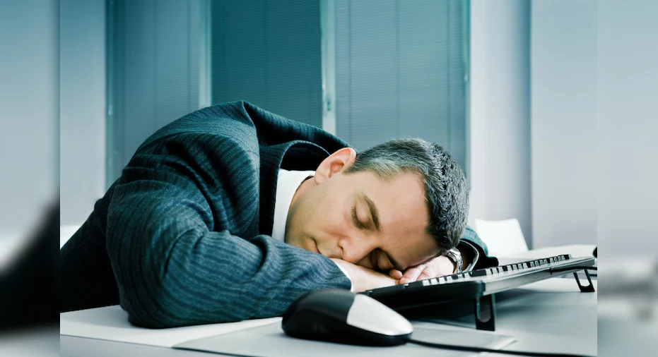 68ad06f1-Businessman-sleeping-at-desk.webp