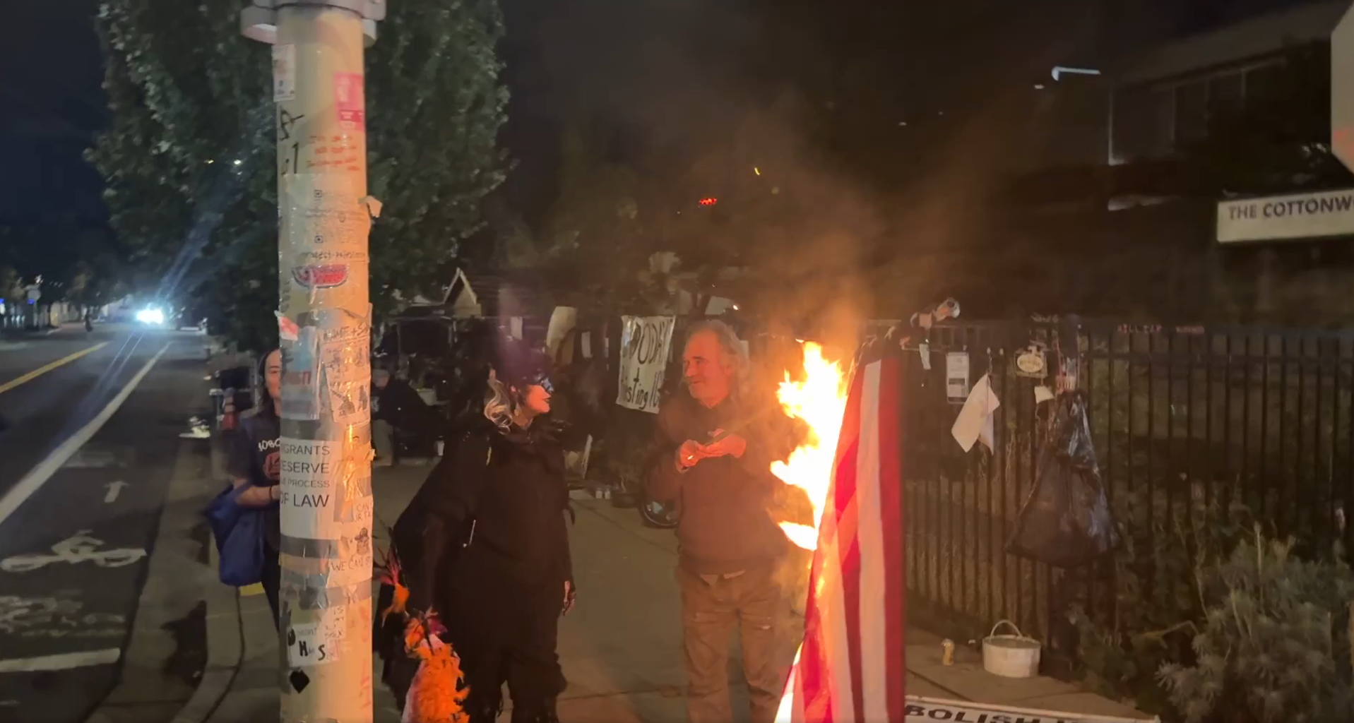 Nick Sortor puts out burning American flag just before being arrested