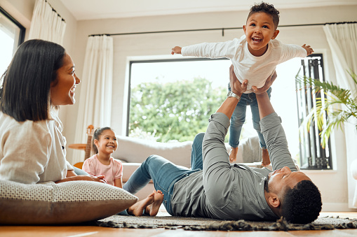 shot-of-a-young-family-playing-together-on-the-lounge-floor-at-home.jpg