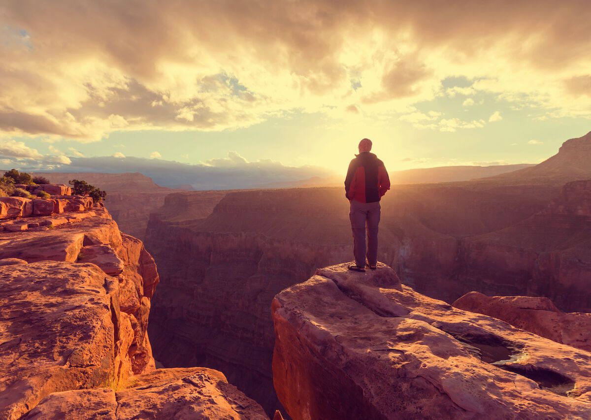 Male-hiker-standing-in-front-of-Grand-Canyon-National-Park-Arizona-1200x853.jpg