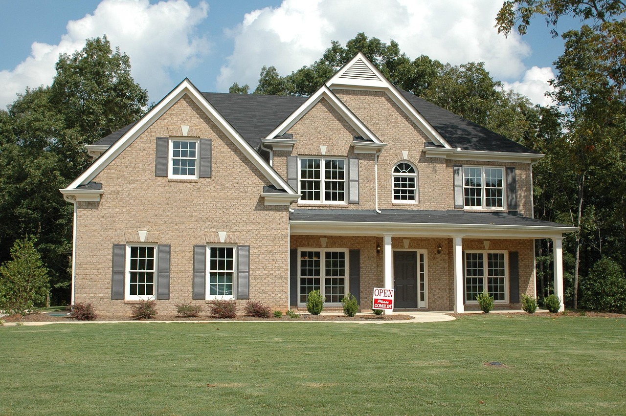“Large two-story brick house with an ‘Open’ sign in the front yard.”