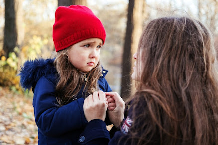 Scared-daughter-holding-mothers-hands-in-autumn-park.-Child-girl-express-sad-emotions-complain-about-their-own-problems-1068508440_2125x1416-scaled-1.jpeg