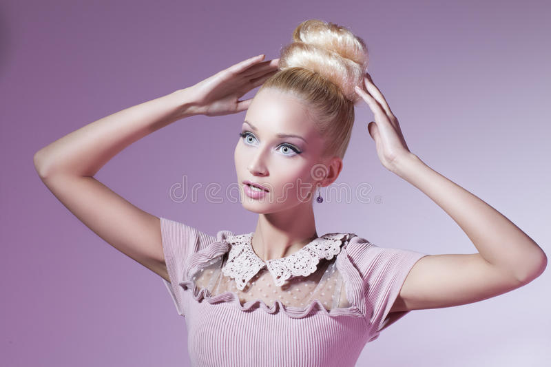 girl-looking-like-barbie-doll-portrait-beautiful-blond-pink-dress-over-pink-background-31678857.jpg