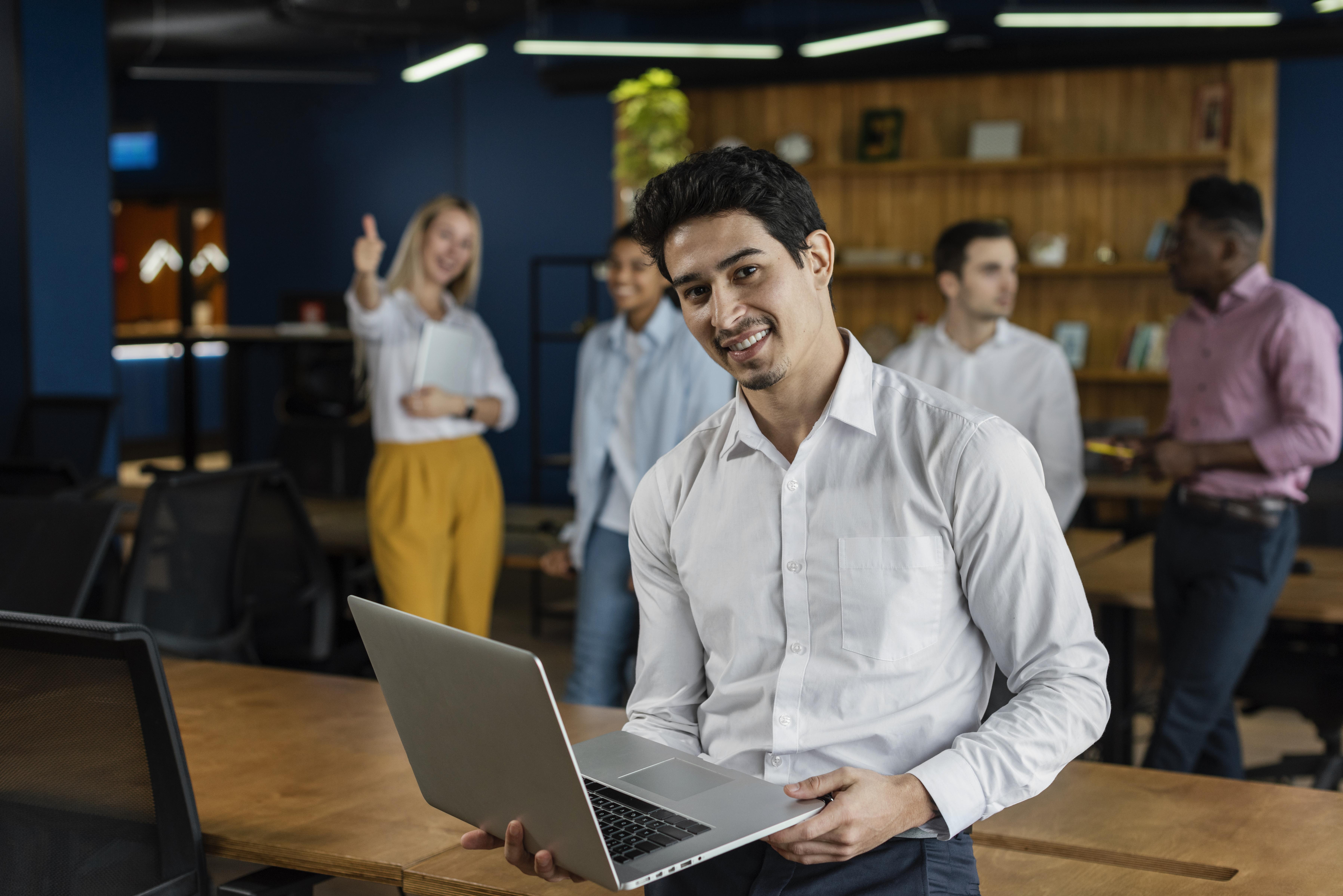 smiley-man-work-holding-laptop-posing.jpg