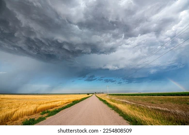storm-clouds-gather-over-road-260nw-2254808509.webp