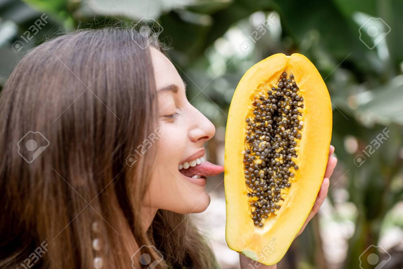 142084024-portrait-of-a-young-woman-licking-papaya-fruit-closeup-view-outdoors-concept-of-vegetarianism-health.jpg