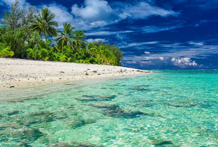 Beach-with-white-sand-and-black-rocks-on-Rarotonga-Cook-Islands.jpg