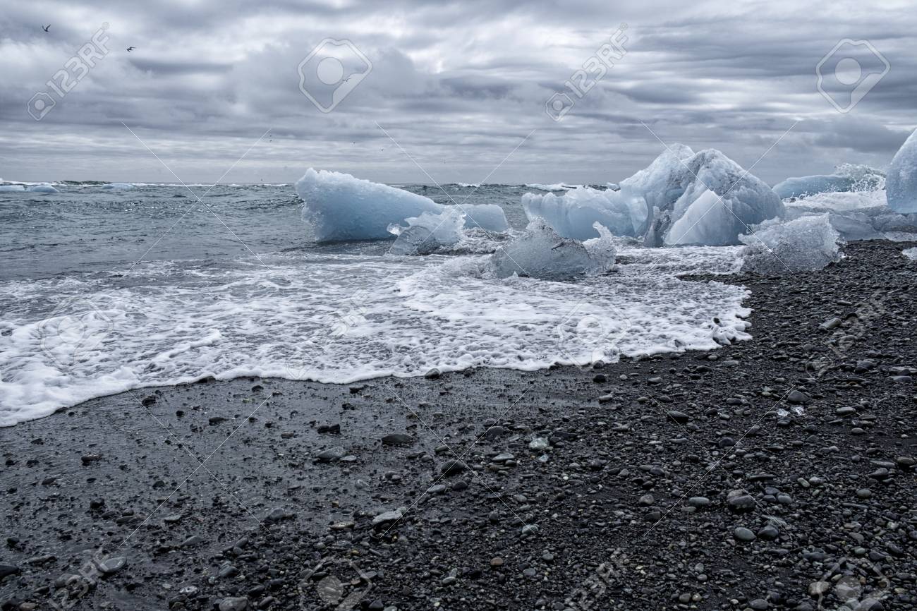 82929952-chunks-of-ice-from-the-glacial-lagoon-in-iceland-on-a-black-volcanic-ash-beach-ice-is-slowly-melting.jpg